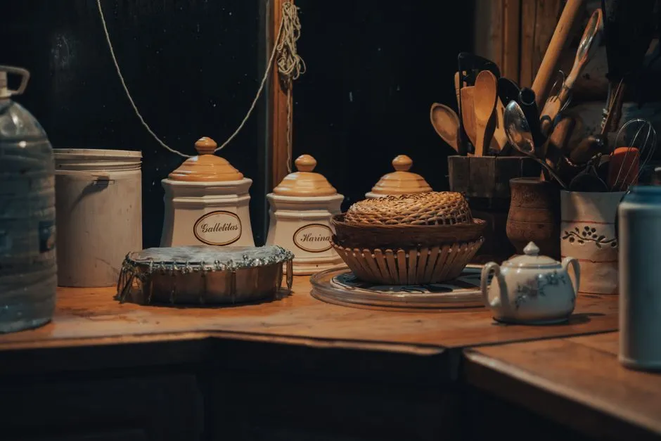 Kitchenware and cooking equipment arranged on a wooden kitchen counter